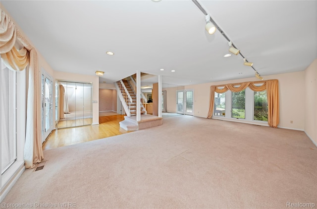 4724 Tara Ct, West Bloomfield, MI 48323 - unfurnished living room featuring light carpet, track lighting, stairs, and recessed lighting