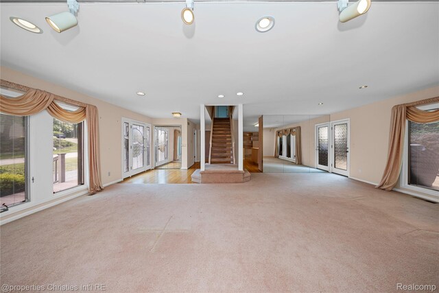 4724 Tara Ct, West Bloomfield, MI 48323 - unfurnished living room with carpet flooring, stairs, recessed lighting, and french doors