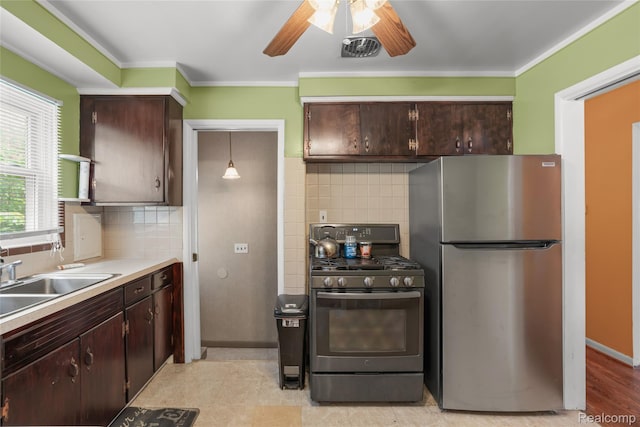 928 N Denwood St, Dearborn, MI 48128 - kitchen featuring stainless steel appliances, ceiling fan, dark brown cabinets, backsplash, and crown molding