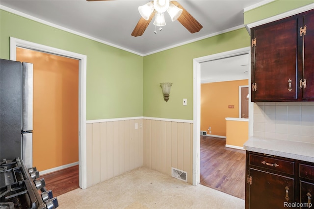 928 N Denwood St, Dearborn, MI 48128 - kitchen featuring freestanding refrigerator, a ceiling fan, backsplash, light countertops, and a wainscoted wall