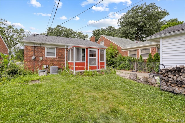928 N Denwood St, Dearborn, MI 48128 - rear view of property with a sunroom, brick siding, roof with shingles, and a chimney