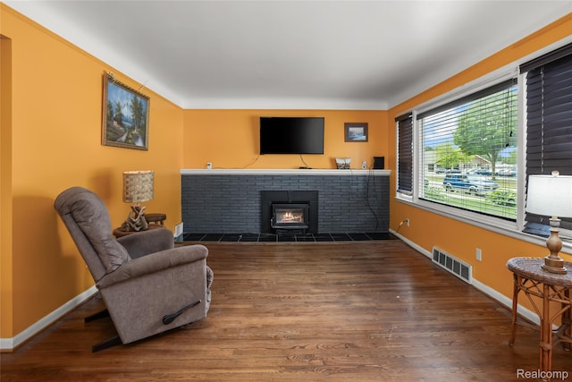 928 N Denwood St, Dearborn, MI 48128 - living area featuring wood finished floors and a brick fireplace