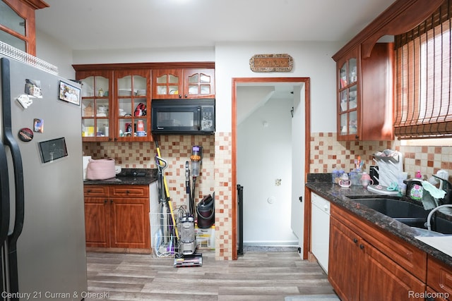 5720 Argyle St, Dearborn, MI 48126 - kitchen with black microwave, stainless steel refrigerator with ice dispenser, dishwasher, backsplash, and light wood-style flooring