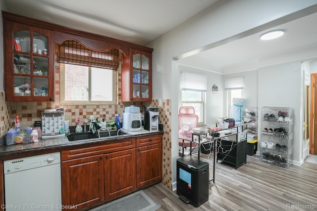 5720 Argyle St, Dearborn, MI 48126 - kitchen with white dishwasher, light wood-type flooring, backsplash, and glass insert cabinets
