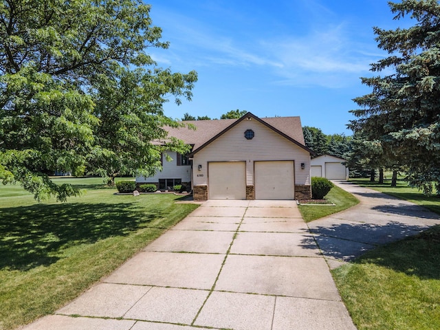 6580 Sunflower Dr SW, Byron Center, MI 49315 - split level home with a front lawn, concrete driveway, a garage, and stone siding