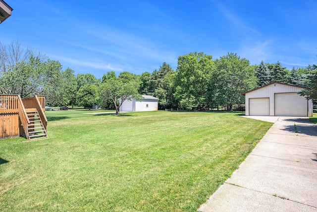 6580 Sunflower Dr SW, Byron Center, MI 49315 - view of green lawn with an outbuilding, stairway, a detached garage, a deck, and view of scattered trees
