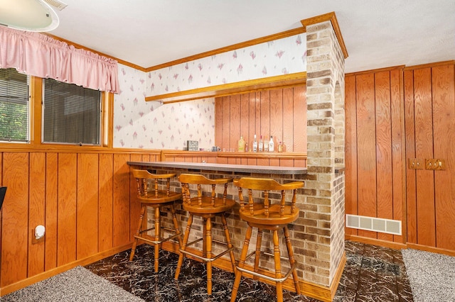6580 Sunflower Dr SW, Byron Center, MI 49315 - indoor dry bar featuring wooden walls, marble look tiles, and ornamental molding