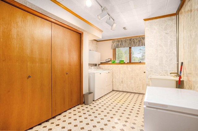 6580 Sunflower Dr SW, Byron Center, MI 49315 - laundry area with washer and clothes dryer, tile walls, rail lighting, ornamental molding, and light floors
