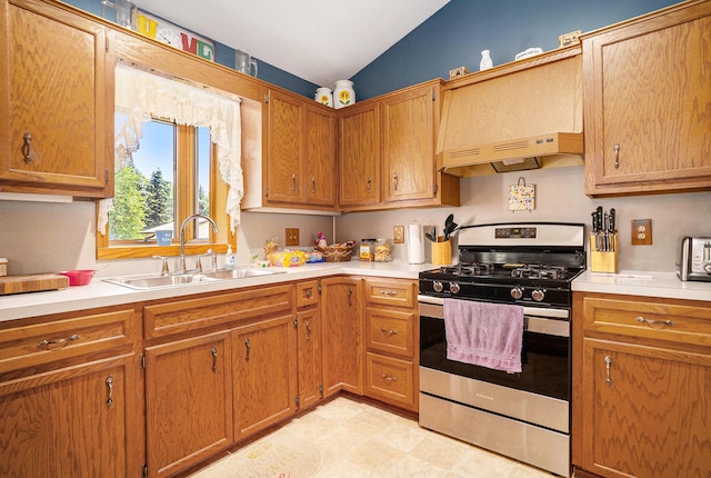 6580 Sunflower Dr SW, Byron Center, MI 49315 - kitchen with stainless steel gas range, vaulted ceiling, light countertops, and brown cabinetry