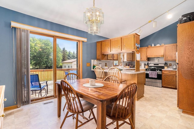 6580 Sunflower Dr SW, Byron Center, MI 49315 - dining room with track lighting, a chandelier, and lofted ceiling