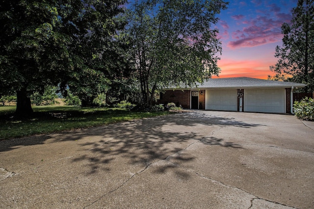 12972 S M 43 Hwy, Delton, MI 49046 - view of front of house featuring driveway, an attached garage, and brick siding