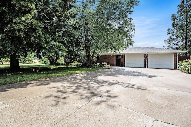 12972 S M 43 Hwy, Delton, MI 49046 - view of front of house featuring asphalt driveway, a garage, and brick siding