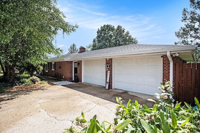 12972 S M 43 Hwy, Delton, MI 49046 - view of front of house with brick siding, an attached garage, a chimney, and concrete driveway