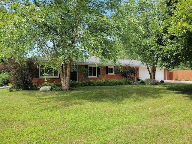 12972 S M 43 Hwy, Delton, MI 49046 - view of front of property featuring an attached garage, brick siding, and driveway