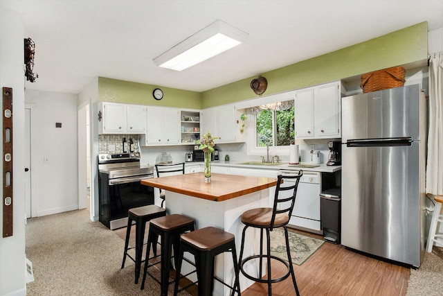 12972 S M 43 Hwy, Delton, MI 49046 - kitchen featuring stainless steel appliances, wood counters, white cabinets, decorative backsplash, and a breakfast bar