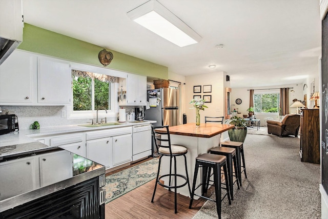 12972 S M 43 Hwy, Delton, MI 49046 - kitchen featuring dishwasher, freestanding refrigerator, white cabinetry, and open floor plan