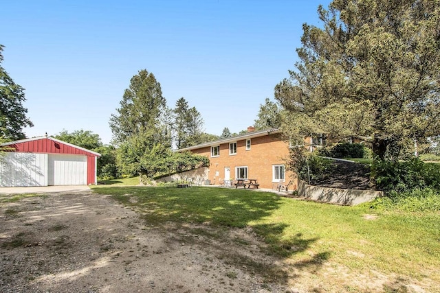 12972 S M 43 Hwy, Delton, MI 49046 - view of green lawn featuring a garage, driveway, an outbuilding, and a pole building
