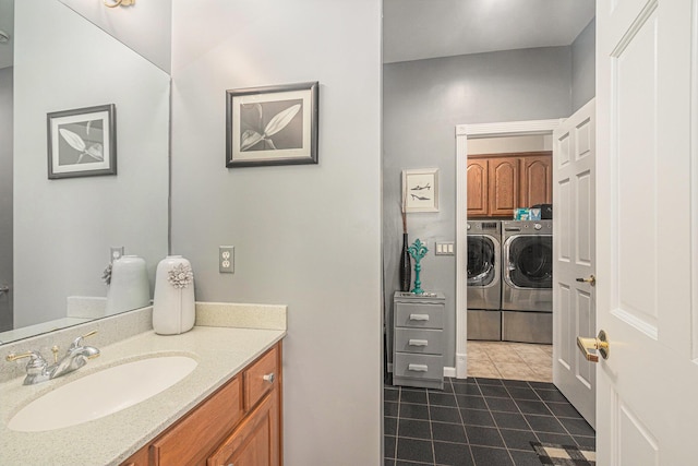 481 Seminole Rd, Norton Shores, MI 49444 - bathroom featuring washer and clothes dryer, tile patterned flooring, and vanity