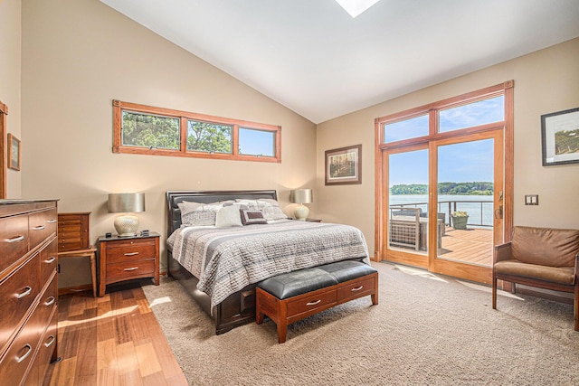 481 Seminole Rd, Norton Shores, MI 49444 - bedroom with access to exterior, light wood-style floors, a water view, and high vaulted ceiling