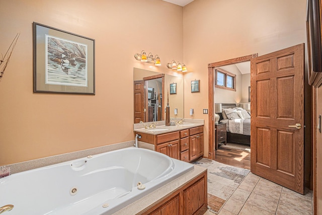481 Seminole Rd, Norton Shores, MI 49444 - ensuite bathroom featuring a tub with jets, double vanity, tile patterned flooring, and a high ceiling