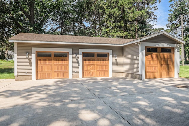 481 Seminole Rd, Norton Shores, MI 49444 - garage featuring concrete driveway