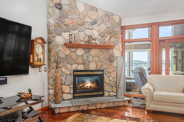 481 Seminole Rd, Norton Shores, MI 49444 - living room featuring wood finished floors and a stone fireplace