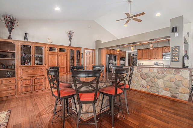 481 Seminole Rd, Norton Shores, MI 49444 - dining area featuring wood finished floors, ceiling fan, and high vaulted ceiling