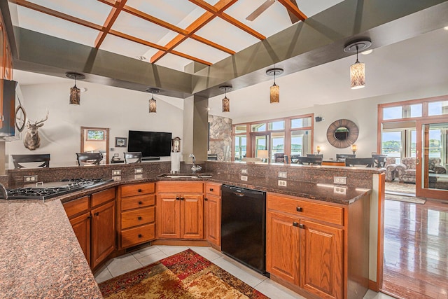 481 Seminole Rd, Norton Shores, MI 49444 - kitchen with black dishwasher, open floor plan, cooktop, stainless steel microwave, and brown cabinets