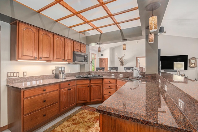 481 Seminole Rd, Norton Shores, MI 49444 - kitchen featuring stainless steel appliances, brown cabinets, pendant lighting, dark stone countertops, and open floor plan