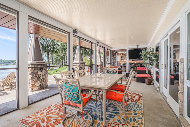 481 Seminole Rd, Norton Shores, MI 49444 - sunroom / solarium featuring a wall of windows, a water view, and outdoor dining space