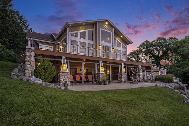 481 Seminole Rd, Norton Shores, MI 49444 - rear view of property with a patio, a lawn, stone siding, a wooden deck, and stairway