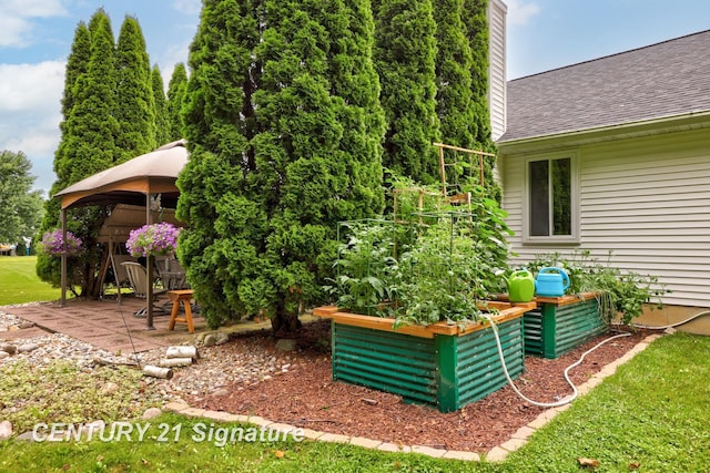 11315 Grand Oaks Dr, Clio, MI 48420 - view of patio featuring a gazebo and a vegetable garden