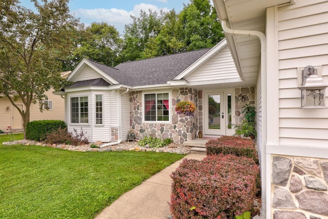 11315 Grand Oaks Dr, Clio, MI 48420 - view of front of house with a front lawn, a shingled roof, and stone siding