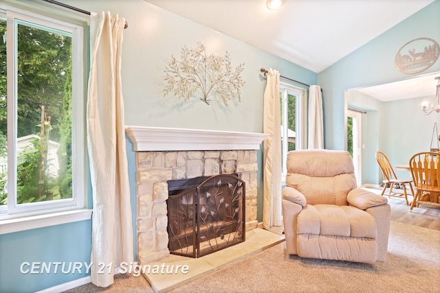 11315 Grand Oaks Dr, Clio, MI 48420 - carpeted living room featuring healthy amount of natural light, vaulted ceiling, a chandelier, and a stone fireplace