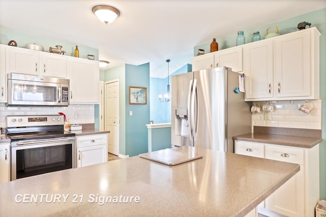 11315 Grand Oaks Dr, Clio, MI 48420 - kitchen with stainless steel appliances, tasteful backsplash, and white cabinetry