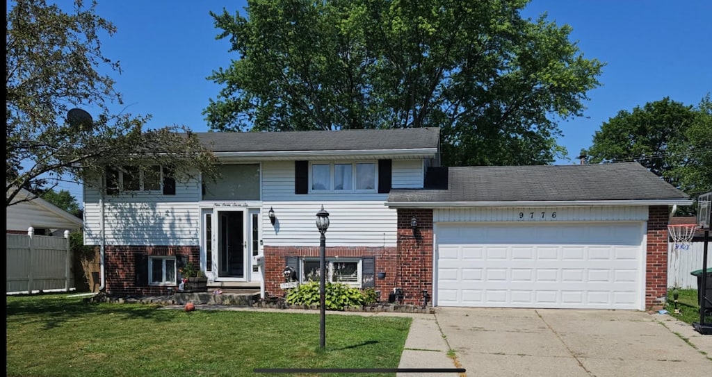 9776 Monroe Blvd, Taylor, MI 48180 - view of front of home featuring brick siding, a garage, and concrete driveway