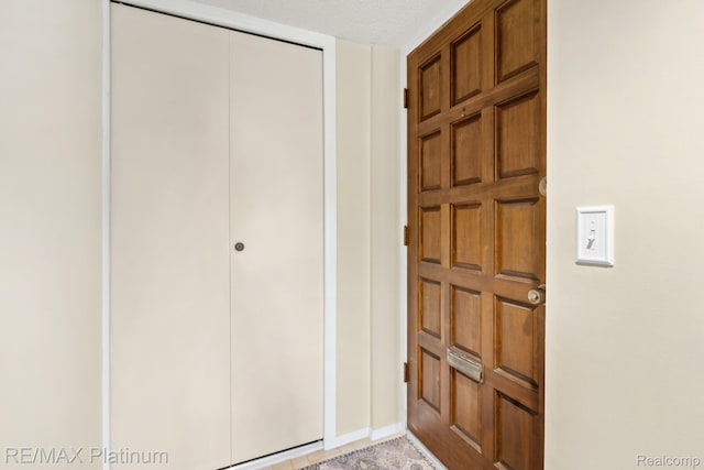 17979 University Park Dr, Livonia, MI 48152 - entryway with baseboards and a textured ceiling