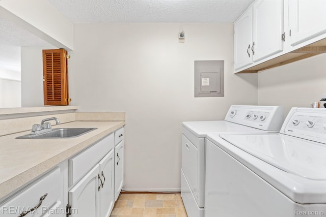17979 University Park Dr, Livonia, MI 48152 - laundry area with washing machine and clothes dryer, electric panel, a textured ceiling, and cabinet space