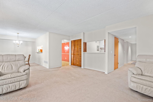 17979 University Park Dr, Livonia, MI 48152 - living room featuring light carpet, a chandelier, and a textured ceiling