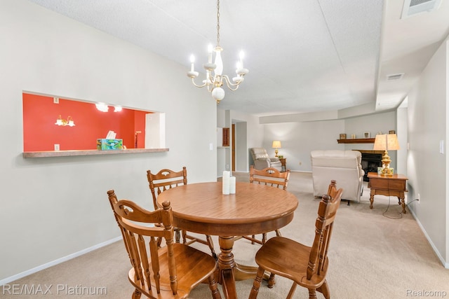 17979 University Park Dr, Livonia, MI 48152 - dining space featuring carpet, a chandelier, and a fireplace