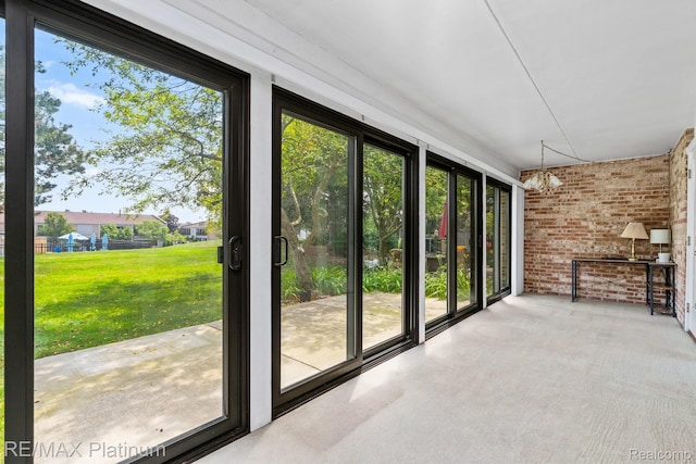 17979 University Park Dr, Livonia, MI 48152 - unfurnished sunroom featuring brick wall