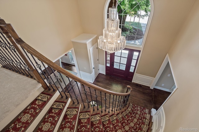 1257 Lake Shore Blvd, Lake Orion, MI 48362 - foyer with a towering ceiling, a chandelier, wood finished floors, wainscoting, and stairway