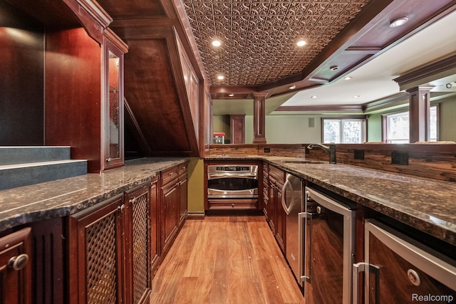 1257 Lake Shore Blvd, Lake Orion, MI 48362 - indoor bar with oven, ornate columns, light wood finished floors, crown molding, and beverage cooler
