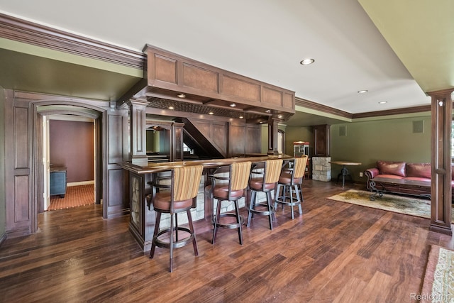 1257 Lake Shore Blvd, Lake Orion, MI 48362 - indoor dry bar with ornate columns, dark wood finished floors, crown molding, arched walkways, and recessed lighting