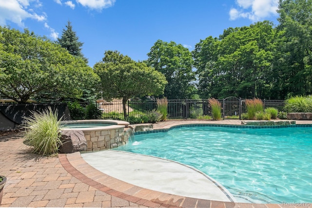 1257 Lake Shore Blvd, Lake Orion, MI 48362 - view of pool featuring a pool with connected hot tub and view of scattered trees