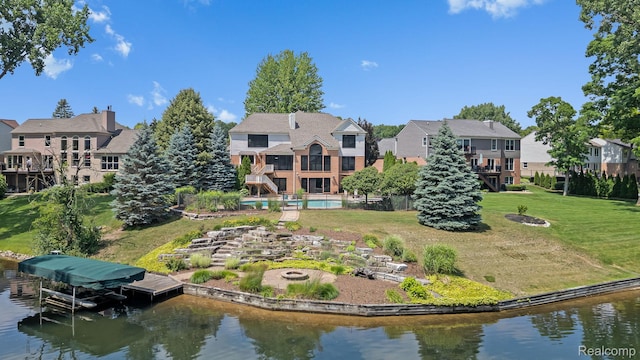 1257 Lake Shore Blvd, Lake Orion, MI 48362 - back of property with a fire pit, a water view, a lawn, and a residential view