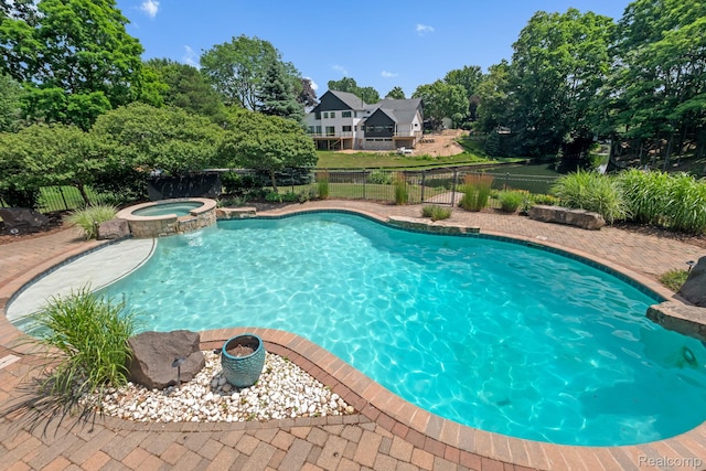 1257 Lake Shore Blvd, Lake Orion, MI 48362 - view of swimming pool featuring a fenced backyard, a pool with connected hot tub, and view of scattered trees