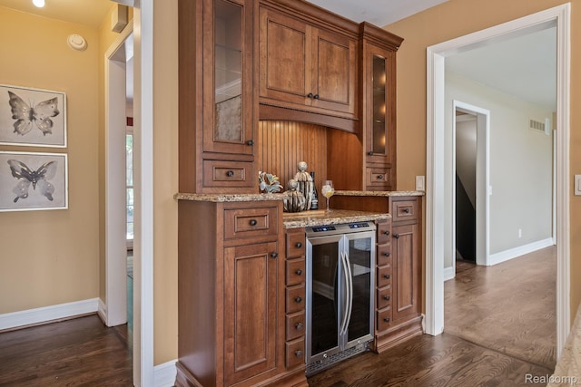 1257 Lake Shore Blvd, Lake Orion, MI 48362 - kitchen featuring wine cooler, dark wood-style floors, brown cabinets, and light stone counters