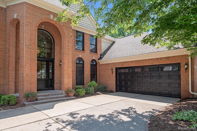 1257 Lake Shore Blvd, Lake Orion, MI 48362 - view of front of home featuring brick siding, concrete driveway, a shingled roof, and an attached garage