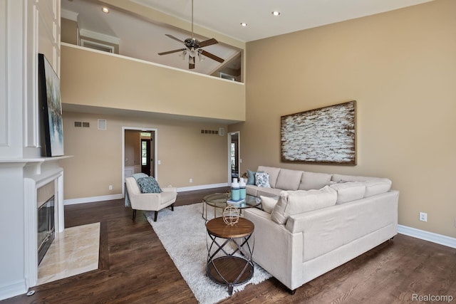 1257 Lake Shore Blvd, Lake Orion, MI 48362 - living area with a tile fireplace, a ceiling fan, dark wood-style flooring, recessed lighting, and a high ceiling